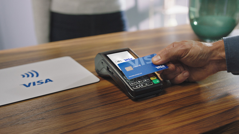 Visa Debit contactless terminal payment_photo_800x450px Contactless payment with Visa Debit card in a shop.