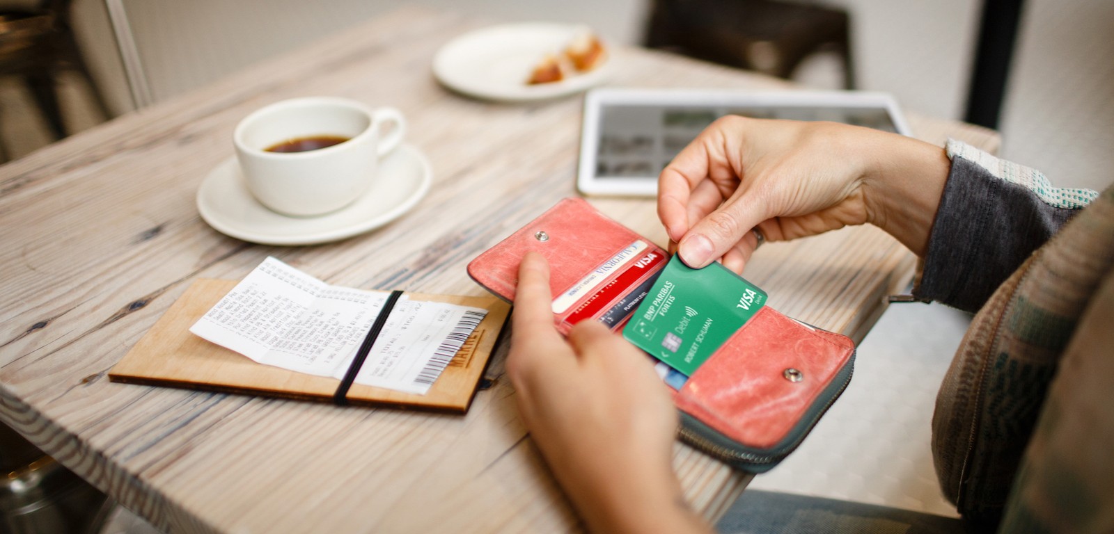 person-taking-a-card-from-wallet-1600x768 person taking a card from wallet