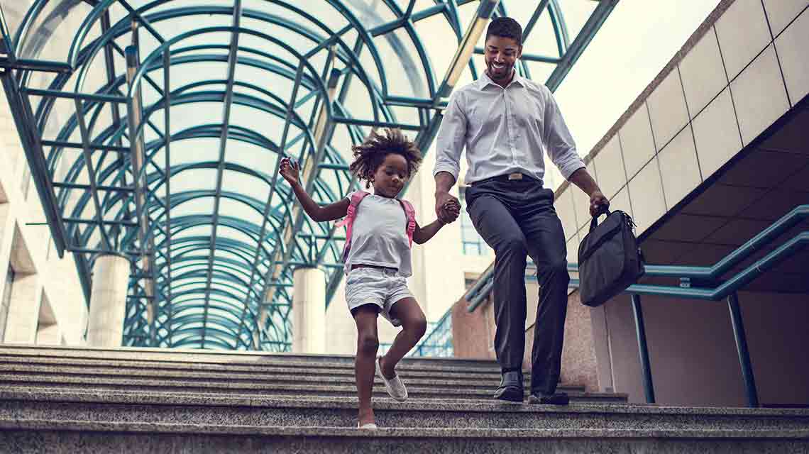 Man walking down stairs with child