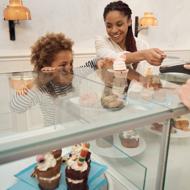 Family paying for cakes